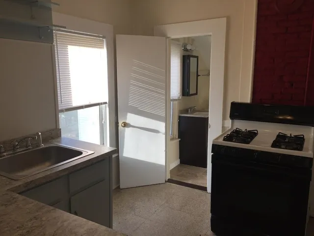 a kitchen that has a sink and a stove