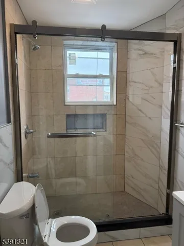 a bathroom with a toilet and a shower