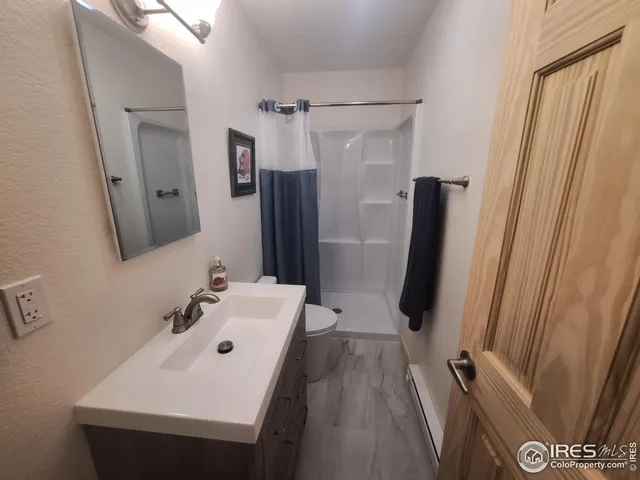 a bathroom with a sink a mirror and shower
