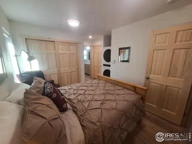a bedroom with a bed and a mirror