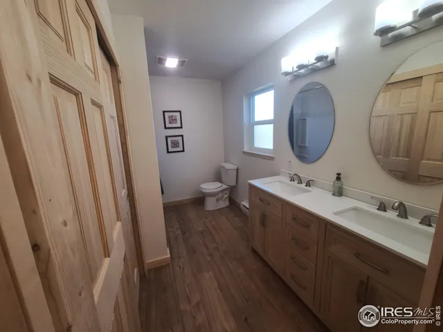a bathroom with 2 sink and a mirror
