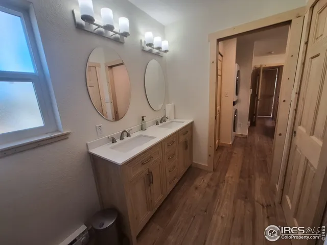 a bathroom with a double vanity sink mirror and shower