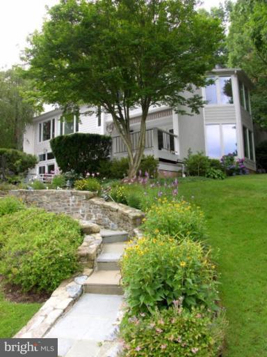 2204 Spinnaker Court Reston, VA 20191 - Photo 3 of 20 a front view of a house with a yard and potted plants