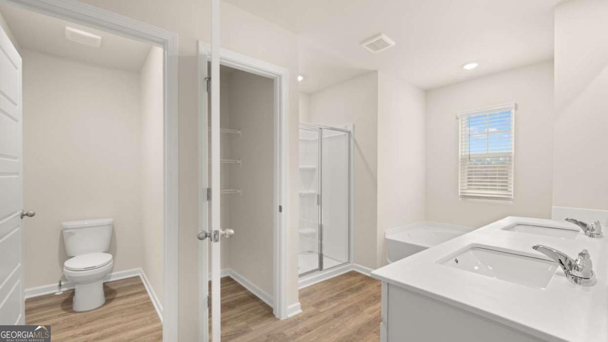 202 Cattle Drive Perry, GA 31069 - Photo 12 of 30 a bathroom with a sink toilet and shower