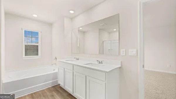 a bathroom with a bathtub and a sink