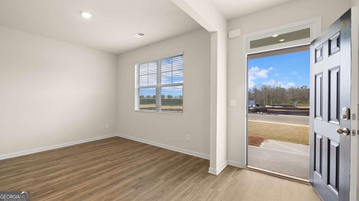 202 Cattle Drive Perry, GA 31069 - Photo 17 of 30 a view of an empty room with a window and wooden floor