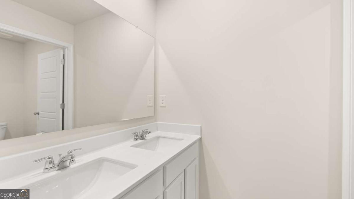 202 Cattle Drive Perry, GA 31069 - Photo 22 of 30 a bathroom with a sink and a mirror