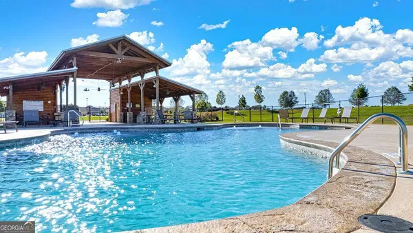 a view of a swimming pool with a lounge chairs