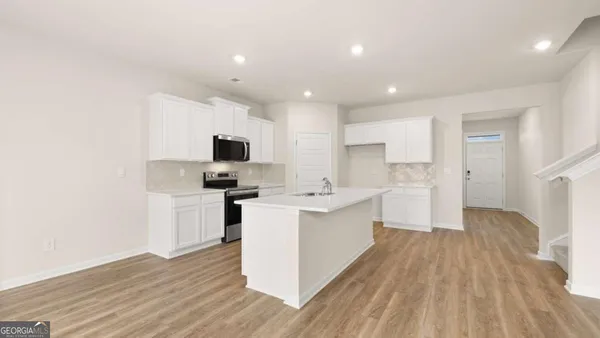 a view of a kitchen with sink and microwave