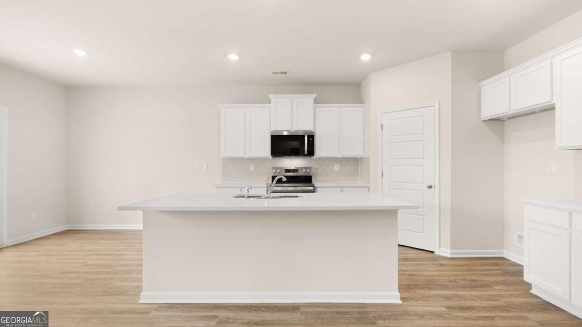 202 Cattle Drive Perry, GA 31069 - Photo 9 of 30 a view of a kitchen with sink and microwave