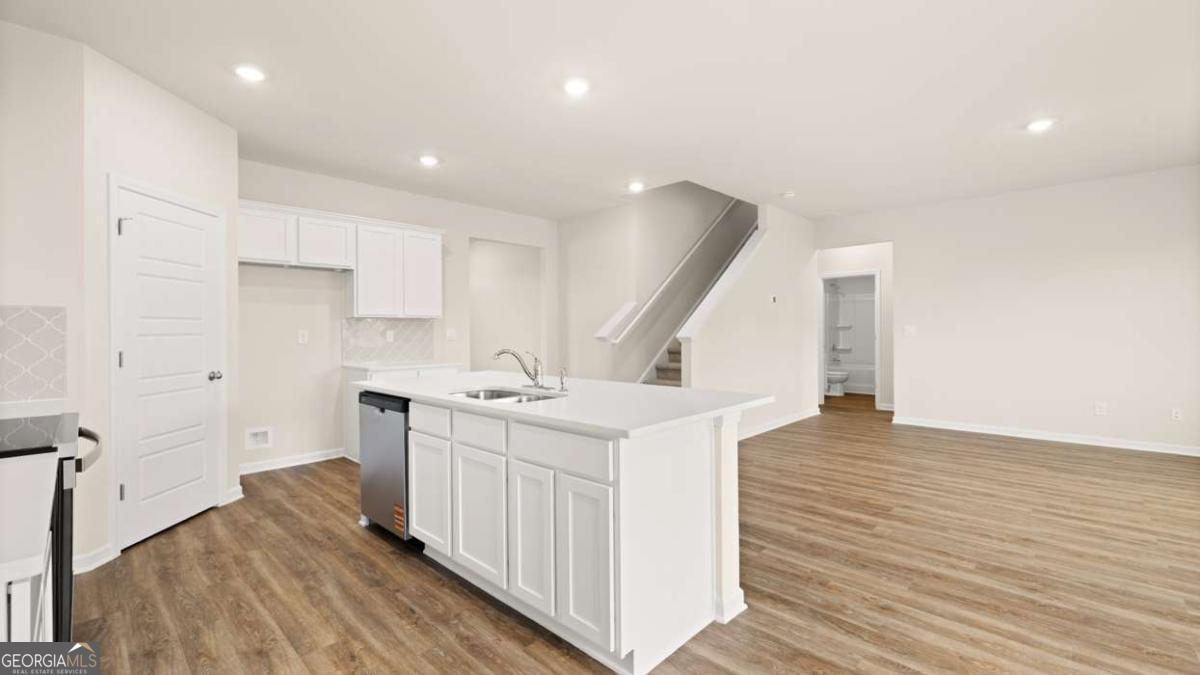 202 Cattle Drive Perry, GA 31069 - Photo 10 of 30 a kitchen with a sink and wooden floor
