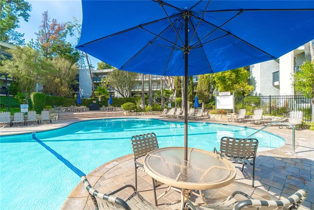 a patio with a table and chairs under an umbrella
