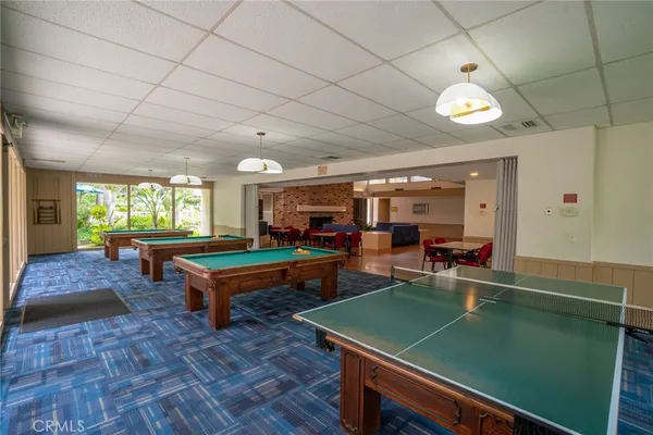 a room with pool table and windows