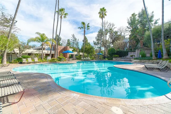a view of a swimming pool with a lawn chairs