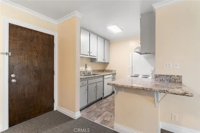 a kitchen with stainless steel appliances granite countertop a sink and a refrigerator
