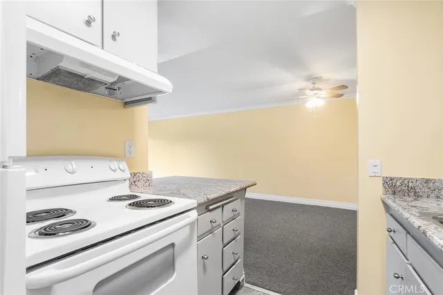 a kitchen with a sink a stove and a refrigerator