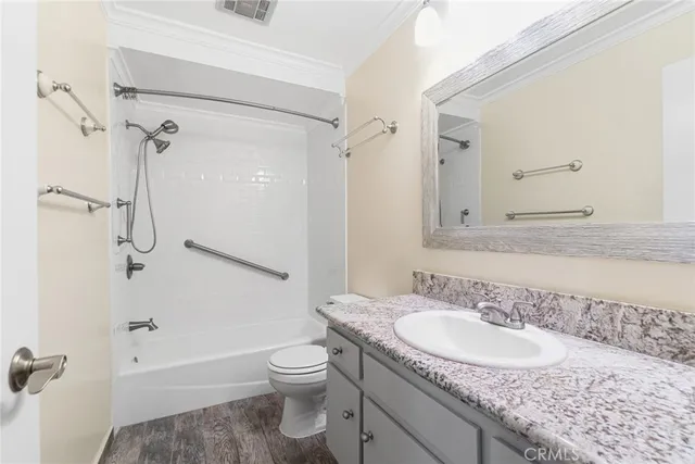 a bathroom with a granite countertop sink toilet and shower