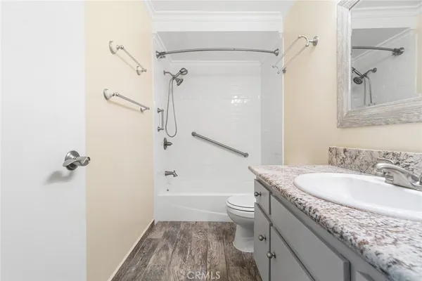 a bathroom with a granite countertop sink toilet and shower