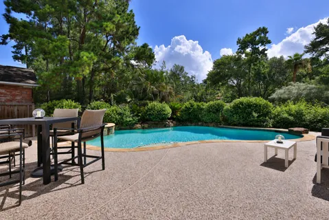 a view of a chairs and table in the back yard