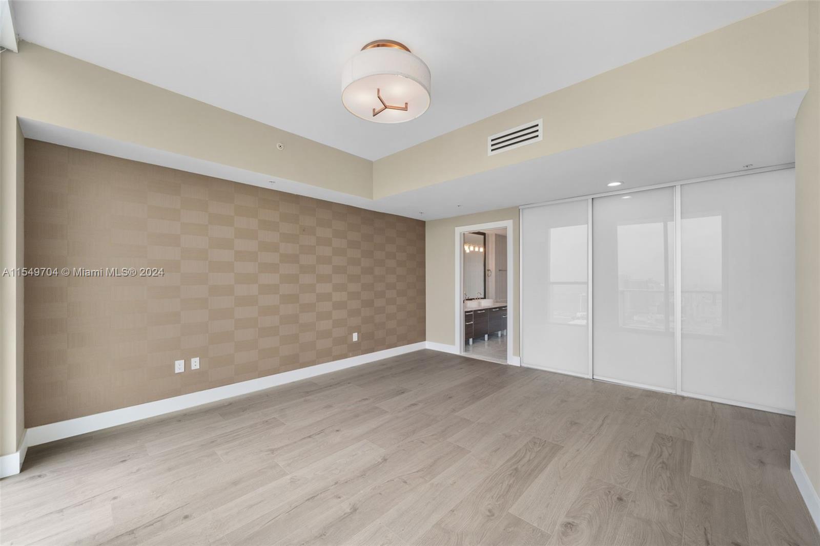 244 Biscayne Boulevard, Unit UPH4904 Miami, FL 33132 - Photo 23 of 49 a view of an empty room with wooden floor