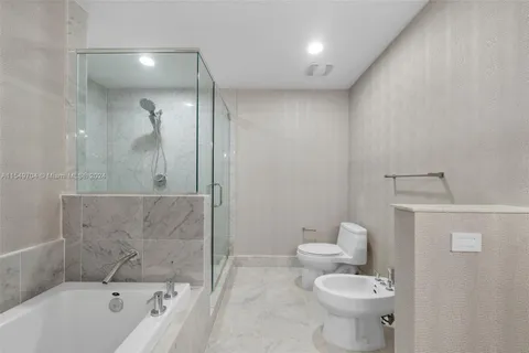 a bathroom with a bathtub and a shower
