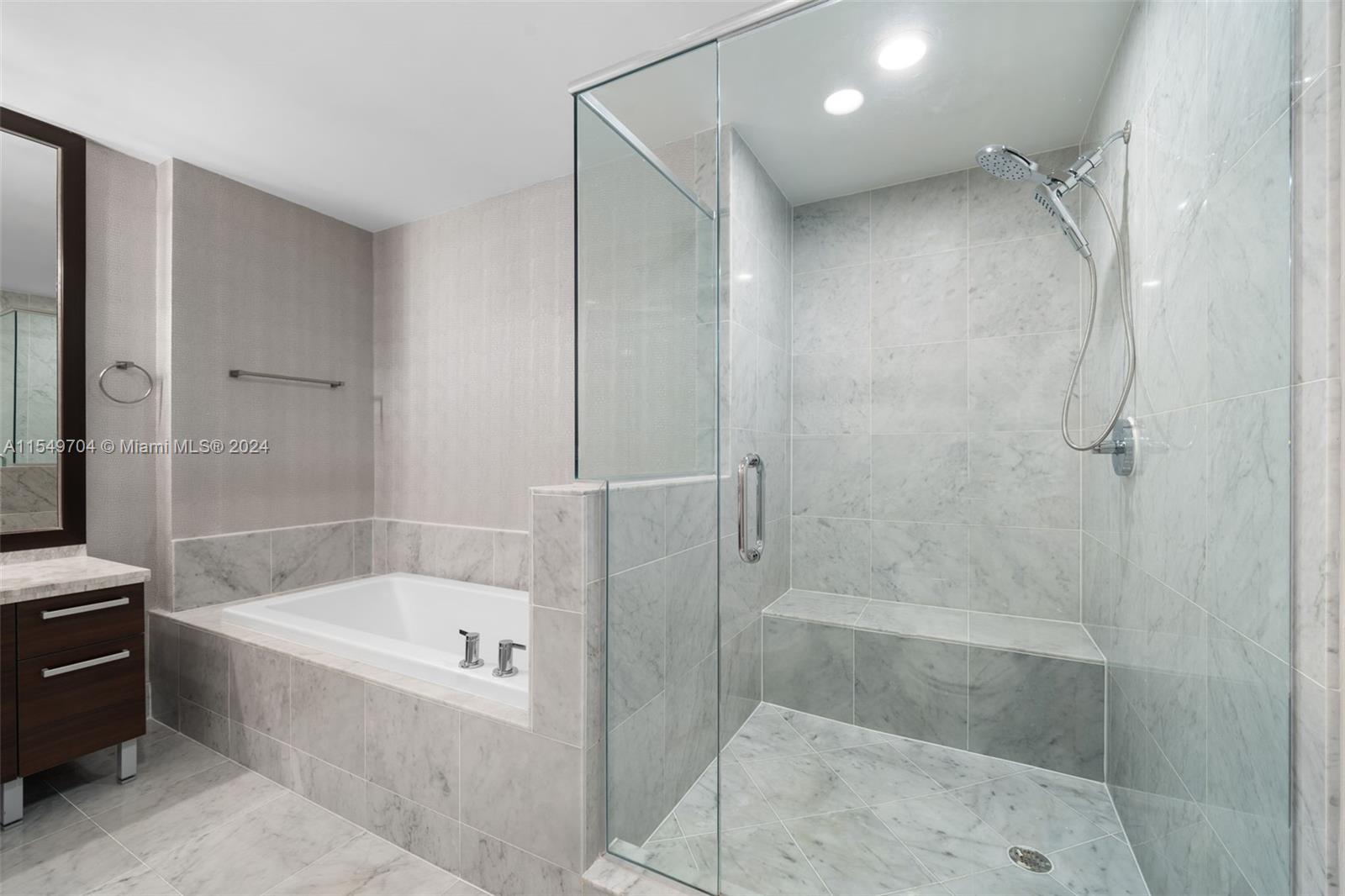 244 Biscayne Boulevard, Unit UPH4904 Miami, FL 33132 - Photo 26 of 49 a bathroom with a bathtub and a shower