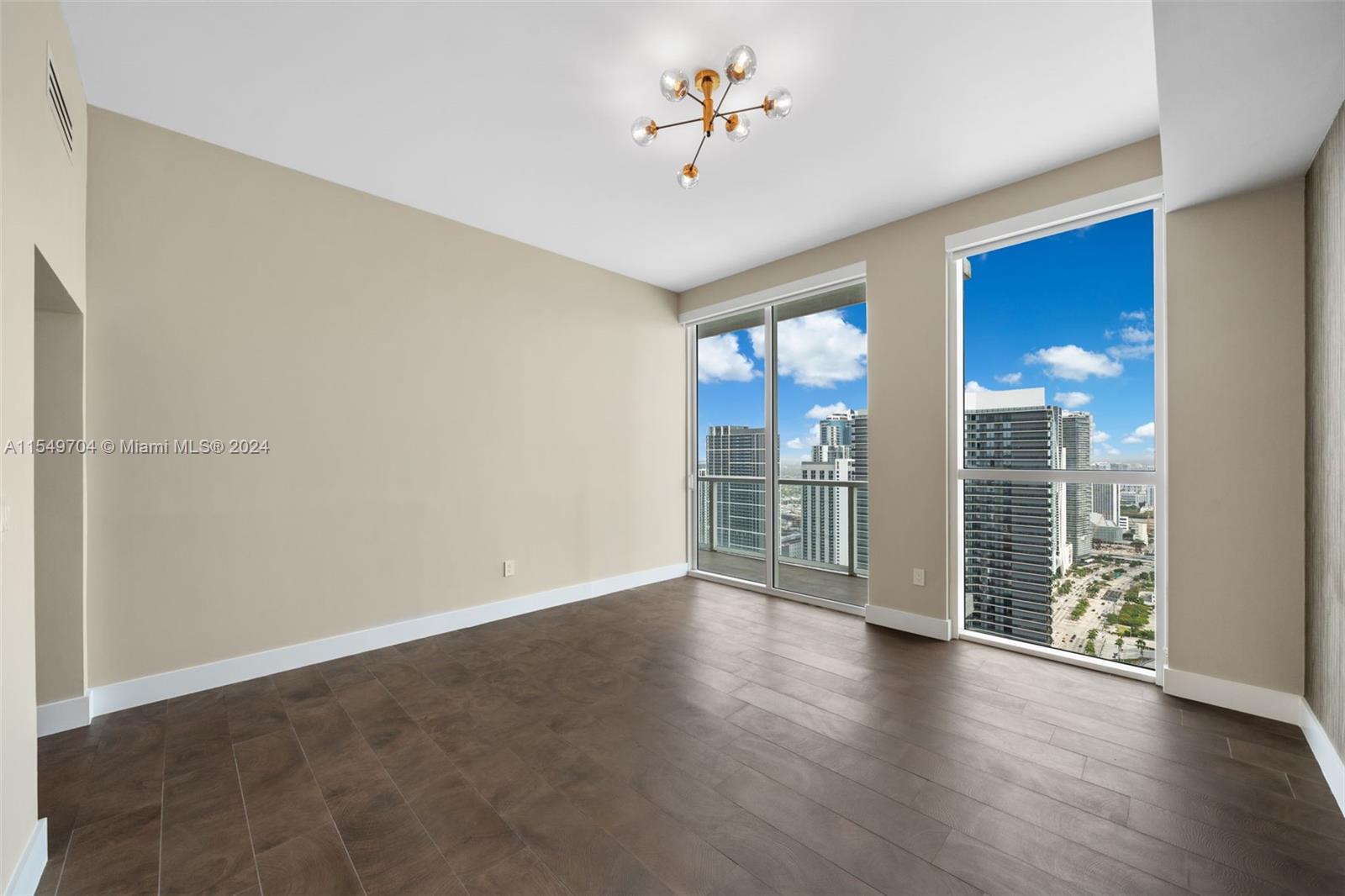 244 Biscayne Boulevard, Unit UPH4904 Miami, FL 33132 - Photo 10 of 49 wooden floor in an empty room with a window
