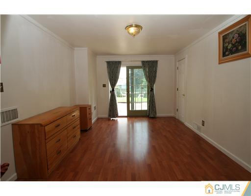 8 Moryan Road Edison, NJ 08817 - Photo 14 of 24 a view of an empty room with wooden floor and a window