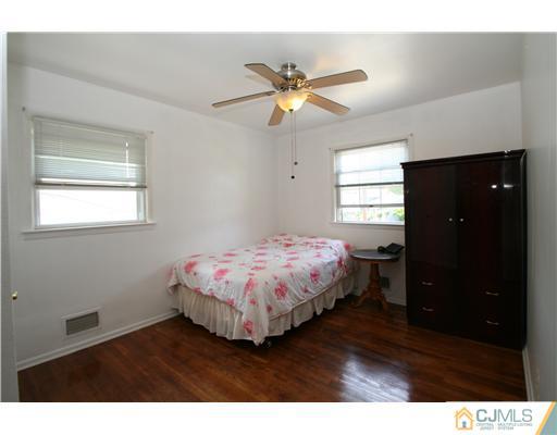8 Moryan Road Edison, NJ 08817 - Photo 22 of 24 a bedroom with a bed and a window