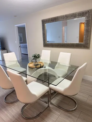 a kitchen with stainless steel appliances a sink a stove a refrigerator and cabinets