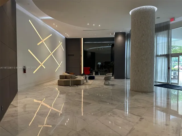 a view of a livingroom with furniture and an empty room