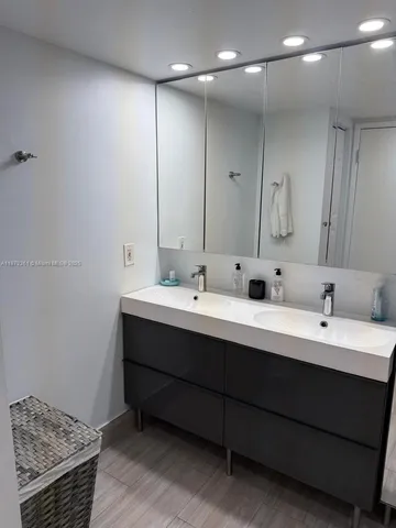 a bedroom with a bed and painting on the wall