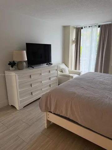 a bathroom with a shower a toilet and a sink