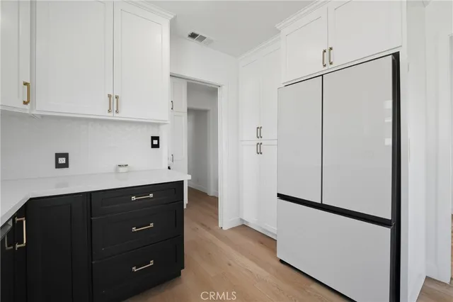 a kitchen with a refrigerator and cabinets