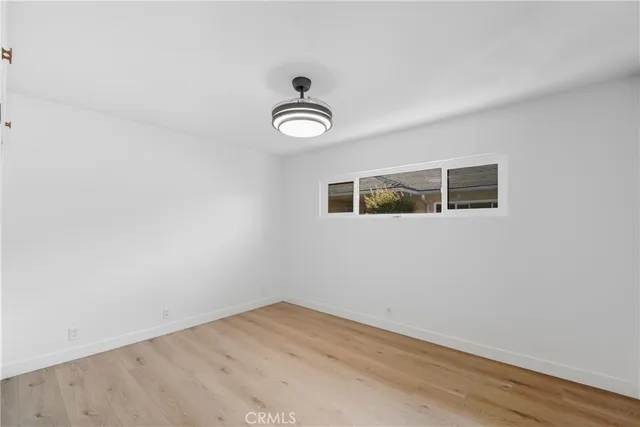 a view of a room with wooden floor and window