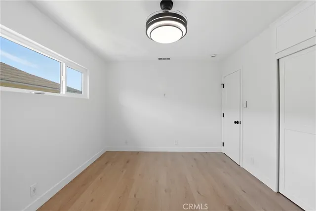 a view of a room with wooden floor and white wall