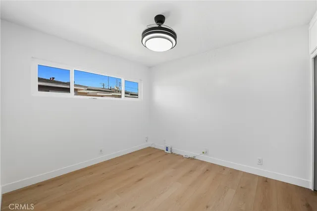 a view of a room with wooden floor