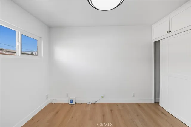 a view of a room with wooden floor and white walls