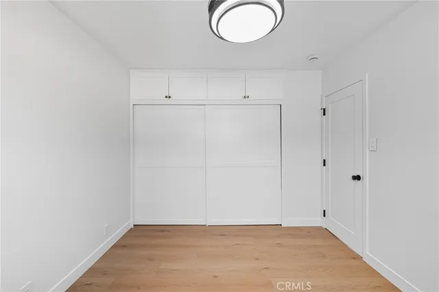 a view of a room with wooden floor and white walls
