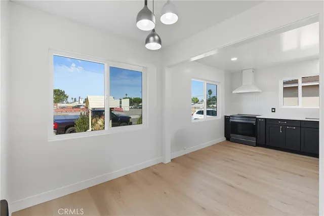 a kitchen with stainless steel appliances granite countertop a sink cabinets and wooden floor