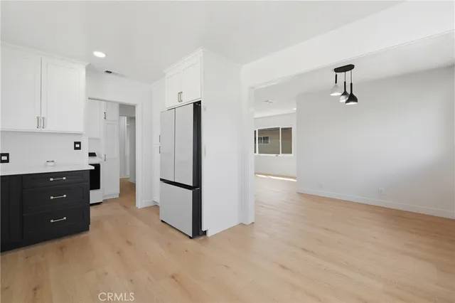 a kitchen with stainless steel appliances a refrigerator and cabinets