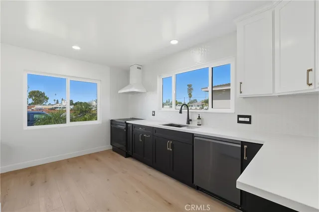 a kitchen with a sink cabinets and window