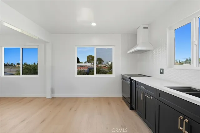 a kitchen with stainless steel appliances a sink a stove and a window