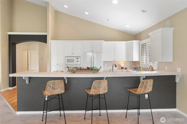 a kitchen with a sink stove and cabinets