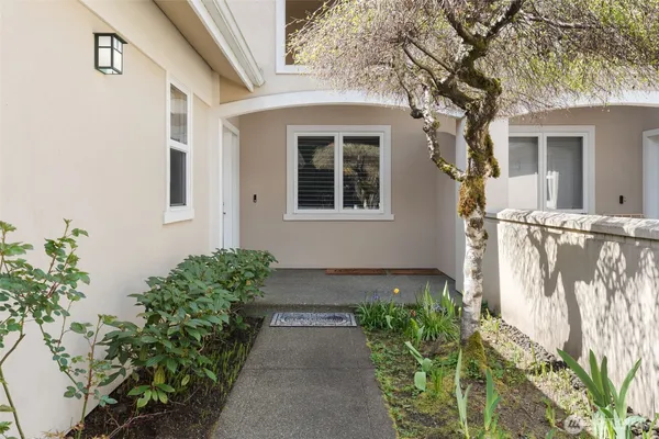 a front view of a house with wooden floor and a potted plant