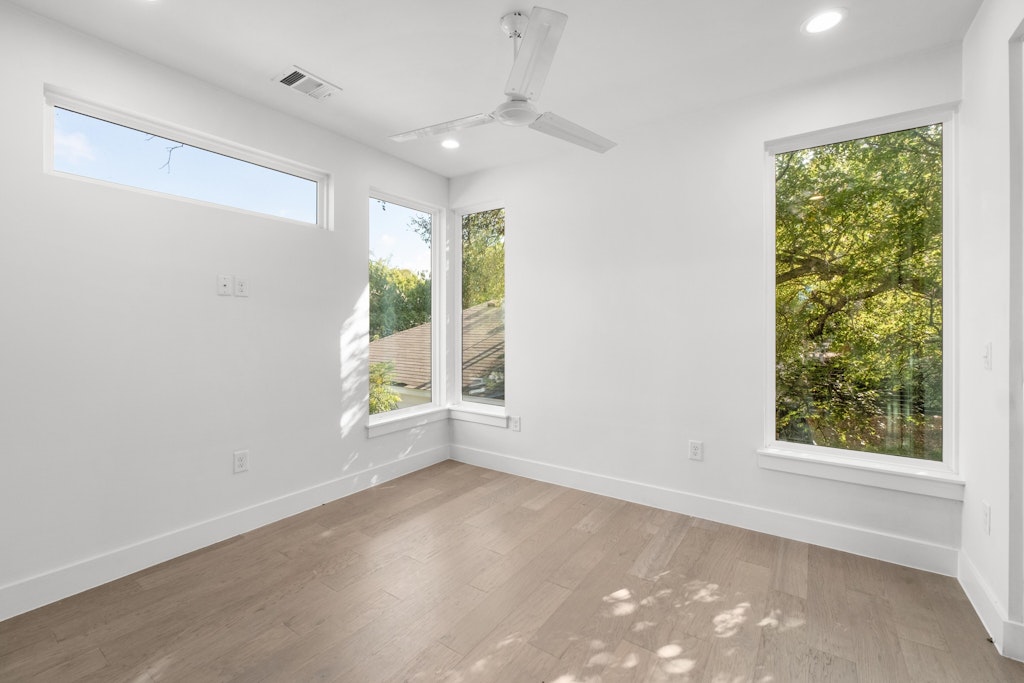 2909 East 13th Street, Unit 2 Austin, TX 78702 - Photo 14 of 23 Empty room with ceiling fan, light wood finished floors, and recessed lighting