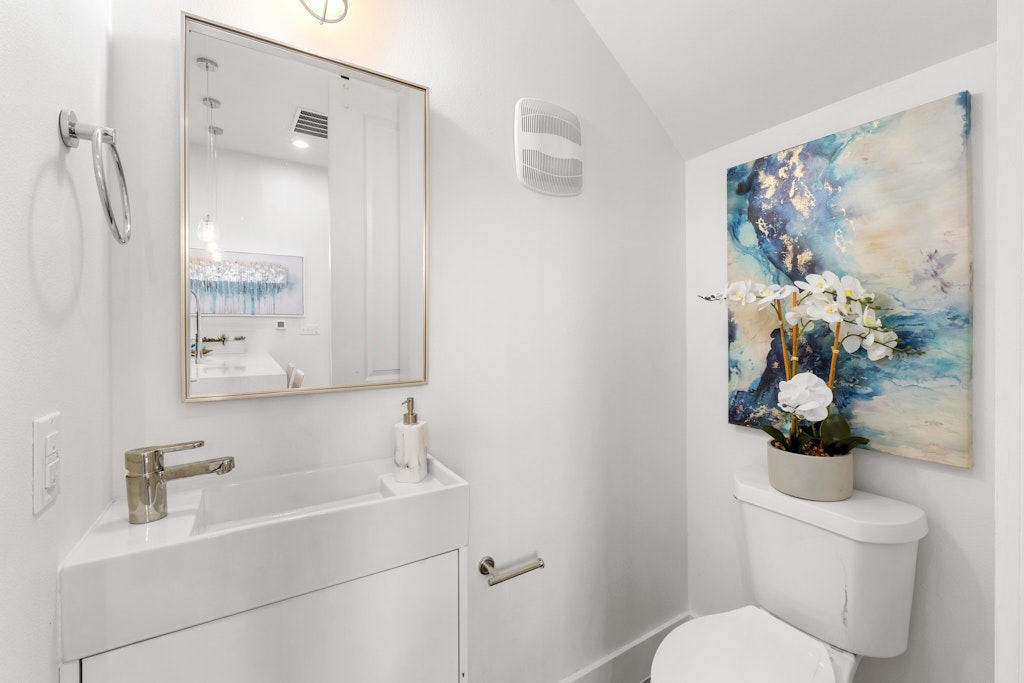 2909 East 13th Street, Unit 2 Austin, TX 78702 - Photo 19 of 23 Half bath featuring vanity and vaulted ceiling