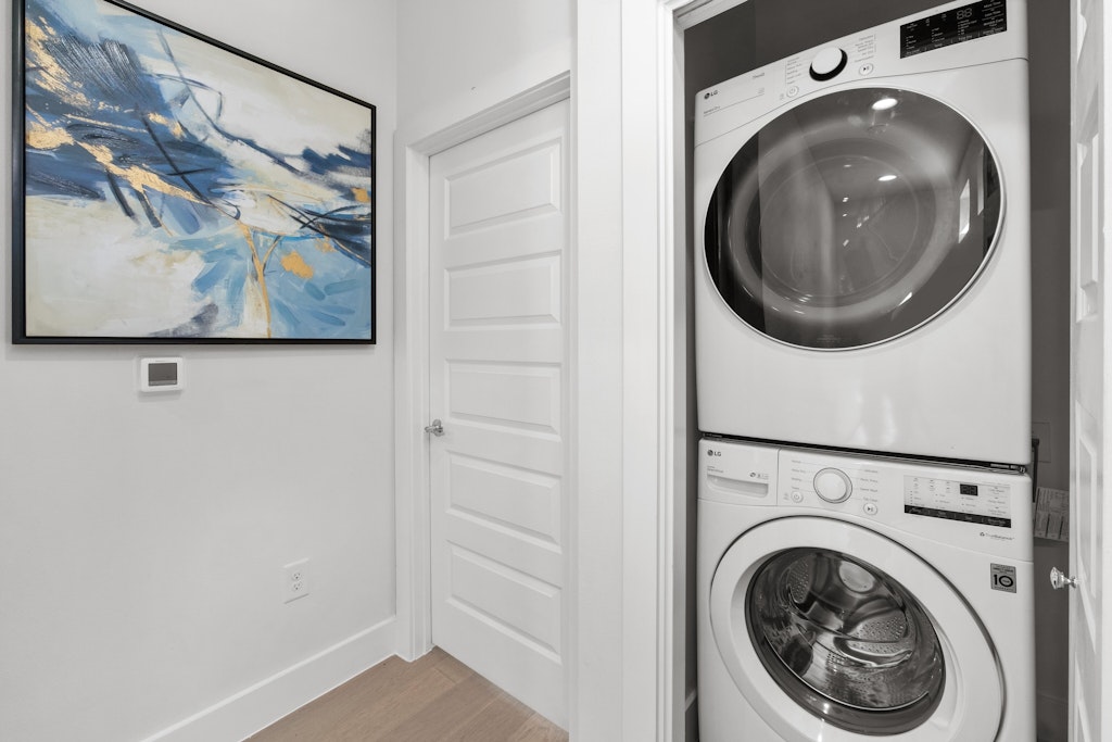 2909 East 13th Street, Unit 2 Austin, TX 78702 - Photo 20 of 23 Laundry area featuring stacked washer / drying machine and wood finished floors