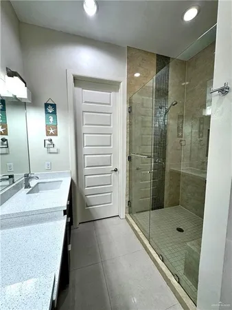 a bathroom with a double vanity sink toilet and shower