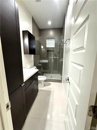 a bathroom with a glass shower door